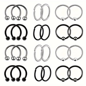 Detailed grid of 24 stainless steel body rings in silver and matte black finishes