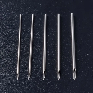 Set of 5 medical stainless steel body piercing needles in various gauge sizes on black