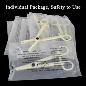 Sterile 43-piece body piercing tool kit with clamps and needles in individual packaging