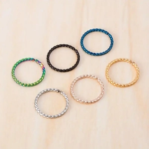 Detailed view of six twist design stainless steel nose rings in multiple metallic colors