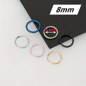 Detail of six 8mm twisted stainless steel nose rings in various metallic colors