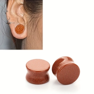 Detail view of brown goldstone ear plugs with shimmering metallic particles