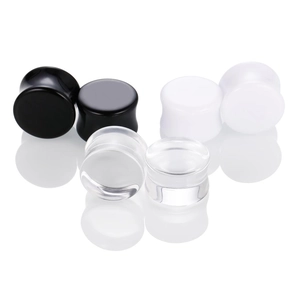 Detailed view of 3 pairs of acrylic heart ear gauges in black, white and clear colors