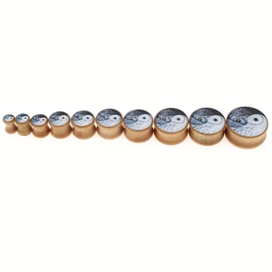 Detailed set of 11 wood ear plugs with owl eye patterns in various sizes on white background