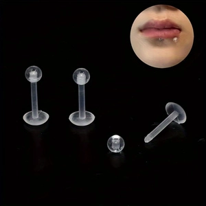 Set of clear acrylic labret studs with flat back and screw balls on black background