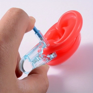 Disposable ear piercing gun kit with built-in earring and blue manual tool for body piercing