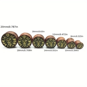 Lion head wooden ear gauges in sizes from 8mm to 20mm on white background