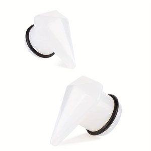 Macro view of white translucent geometric ear plugs with black rubber O-rings