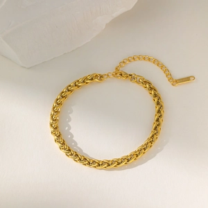 Close-up of golden stainless steel wheat chain bracelet with lobster clasp and extender