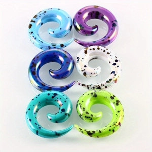 Polished acrylic spiral ear tapers with artistic splatter patterns in multiple colors