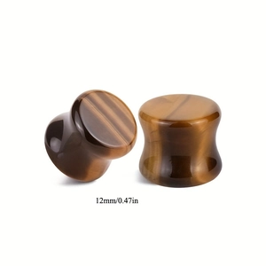 Detailed view of 12mm Tiger Eye stone saddle plugs with smooth polished finish