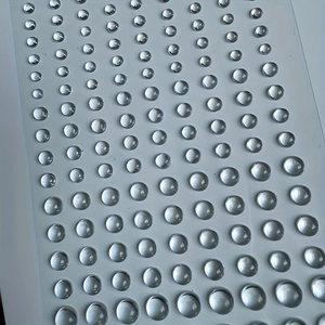 Macro shot of self-adhesive clear resin rhinestone stickers in various sizes for body art