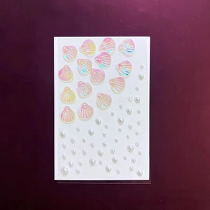 Détails de paillettes de coquillages irisés et de perles blanches pour décoration DIY