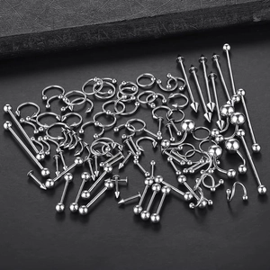 Macro shot of stainless steel piercing kit with circular barbells and spiked ends