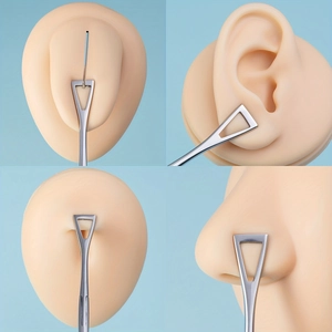 Macro detail of stainless steel body piercing forceps used on professional silicone models