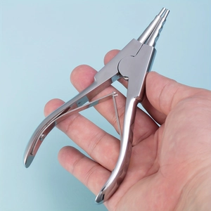 Detail of professional stainless steel opening pliers for body piercing jewelry tools