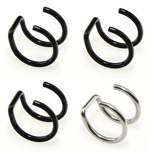 Close-up of four U-shaped stainless steel faux lip rings in black and silver finish