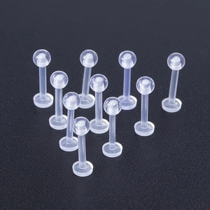 Detailed view of ten transparent acrylic labret studs with flat base and ball top design