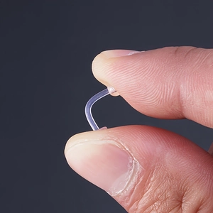 Flexible clear acrylic body piercing retainers showing soft bendable material