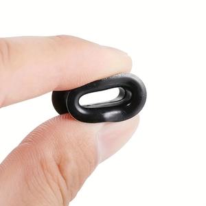 Close-up of a black silicone ear gauge plug showing high flexibility and soft material