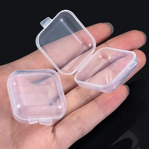 Close-up of small transparent acrylic storage boxes for invisible ear studs set