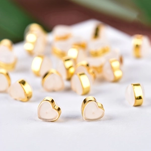 Bulk gold-plated heart-shaped earring backs with cream resin inserts for DIY jewelry making