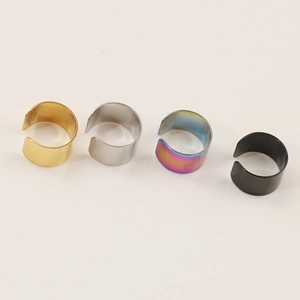 Close-up of a 4-piece set of C-shaped nose rings in gold, silver, rainbow, and black finishes