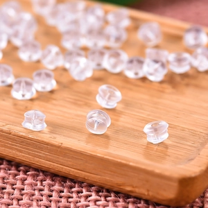 Macro shot of transparent silicone earring backs with bullet shape for stud earrings