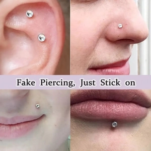 Close-up of fake piercing stickers on skin showing ear and nose placement