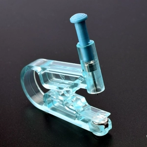 Close-up of disposable ear piercing tool with blue plastic body and steel needle detail