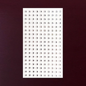 Detailed macro view of 450 self-adhesive crystal face gems for DIY body piercing and makeup