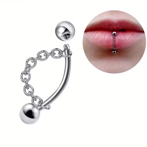 Macro detail of curved stainless steel lip ring with fine chain and internal thread