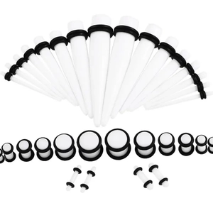 Detailed set of white acrylic ear tapers and plugs with black O-rings in various sizes