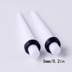 Detailed view of 5mm white acrylic ear taper with black O-rings and size markings