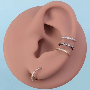 Detail of four multi-color 316L stainless steel seamless rings with paved cubic zirconia