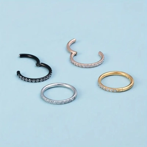 Set of four 316L stainless steel hinged clicker rings with zircon inlay in four colors