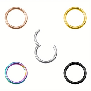Detail of 316L stainless steel seamless clicker rings in five colors with polished finish