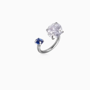 Detailed macro view of the silver bypass ring featuring clear and blue zircon gemstones