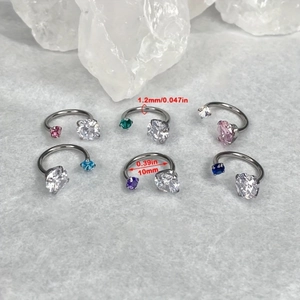 Detail view of 10mm horseshoe piercing rings with sparkling zircon in six vibrant colors