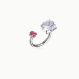 Detailed close-up of open ring with large clear zircon and small pink gemstone