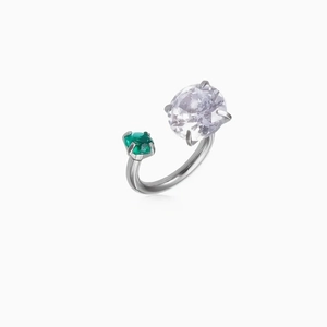 Macro detail of silver ring featuring oval purple zircon and green emerald-cut stone