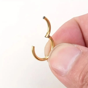 Macro shot of 316L gold stainless steel seamless hinged hoop for nose and ear piercing