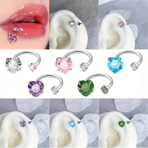 Macro detail of heart-cut zircon horseshoe rings in five vibrant colors for piercings
