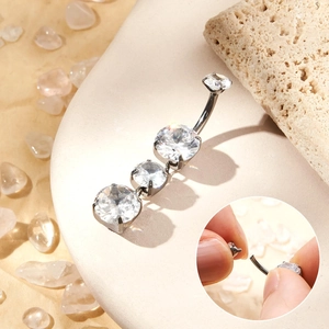 Detailed view of G23 titanium navel ring with gradient zircons and threaded closure