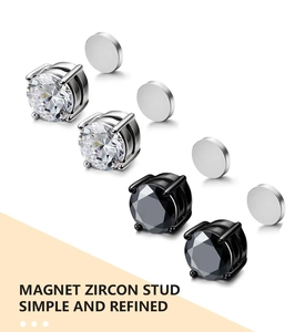 Close-up of magnetic zircon stud earrings in silver and black colors without piercing