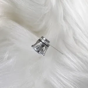 Macro view showing silver magnetic stud earring with a clear cubic zirconia stone
