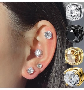 Detailed view of 4-prong magnetic stud earrings with clear and champagne zircons