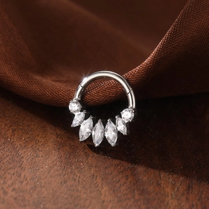 Macro detail of G23 titanium 16G septum ring with 5A grade marquise cut cubic zirconia