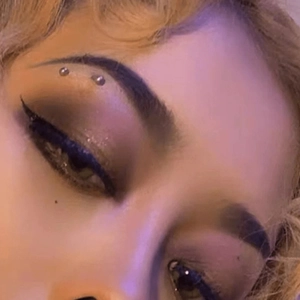 Macro detail of 16G stainless steel eyebrow rings with cubic zirconia on a model