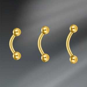 Detailed view of three 16G gold curved barbells with polished double solid beads
